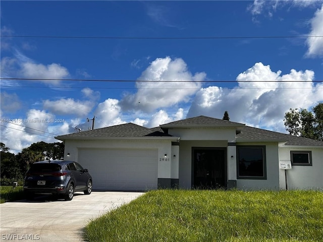 view of front of property featuring a garage and a front yard