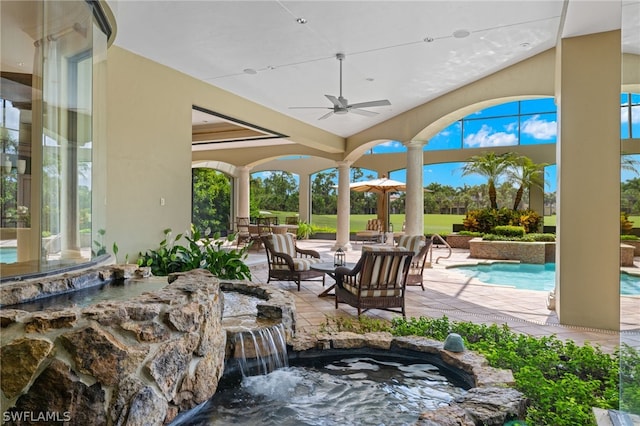 view of patio / terrace featuring pool water feature and ceiling fan