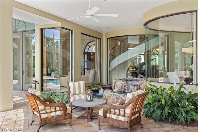 sunroom / solarium with ceiling fan and a healthy amount of sunlight