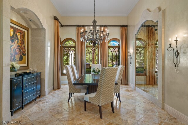 dining area with ornamental molding and a notable chandelier