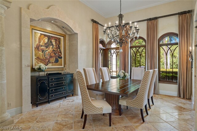 dining space with ornamental molding and a notable chandelier