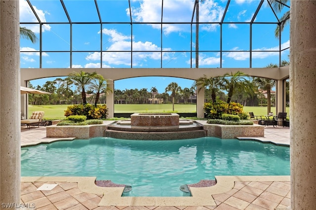 view of swimming pool featuring a lanai and a patio