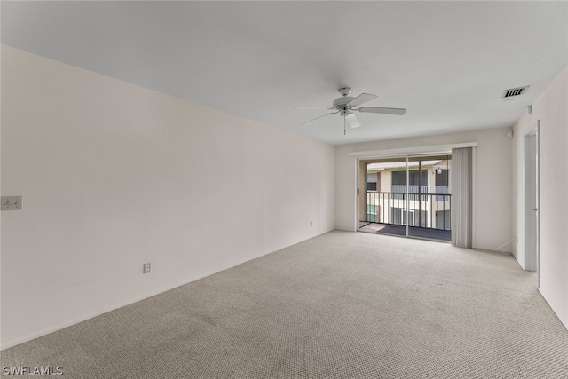 carpeted spare room with ceiling fan