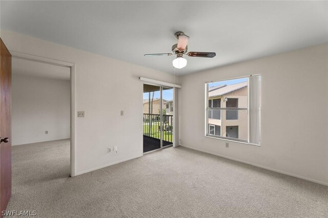 carpeted empty room featuring ceiling fan