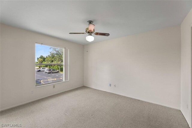 empty room featuring carpet floors and ceiling fan