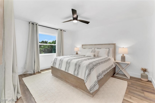 bedroom with light wood-type flooring and ceiling fan