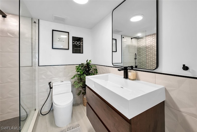 bathroom featuring vanity, tile walls, toilet, and an enclosed shower