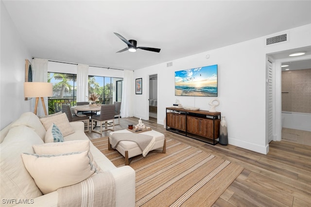 living room with light wood-type flooring and ceiling fan