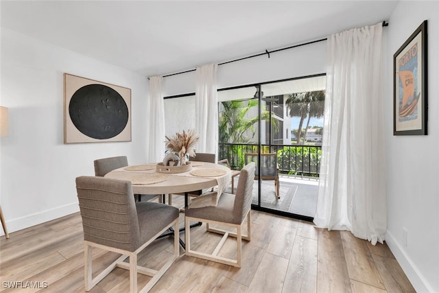 dining space featuring plenty of natural light and light hardwood / wood-style flooring