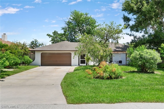 view of front of property featuring a garage and a front lawn