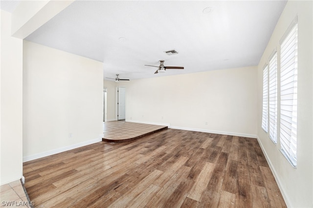 unfurnished living room with ceiling fan and wood-type flooring