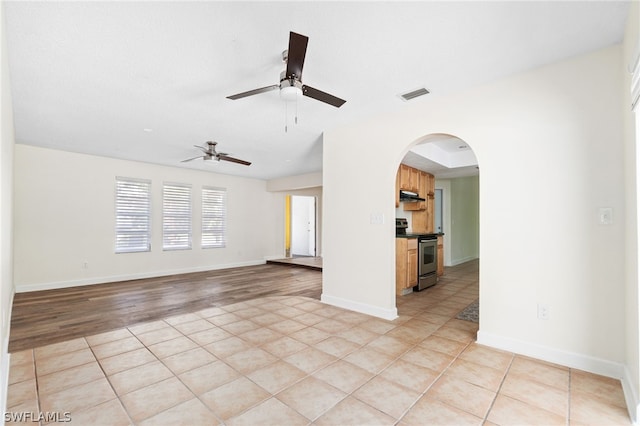 unfurnished living room with light tile patterned floors and ceiling fan