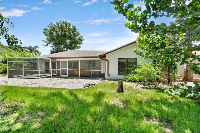 back of property with a sunroom