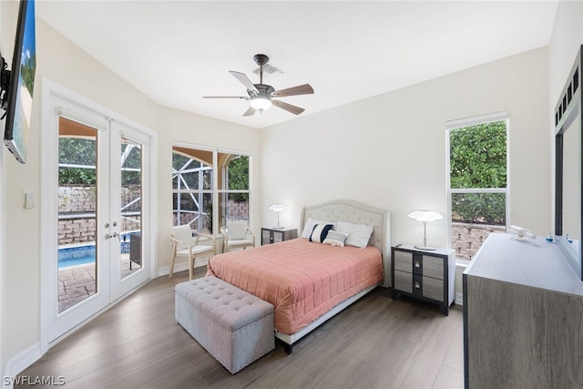 bedroom featuring multiple windows, access to exterior, ceiling fan, and french doors