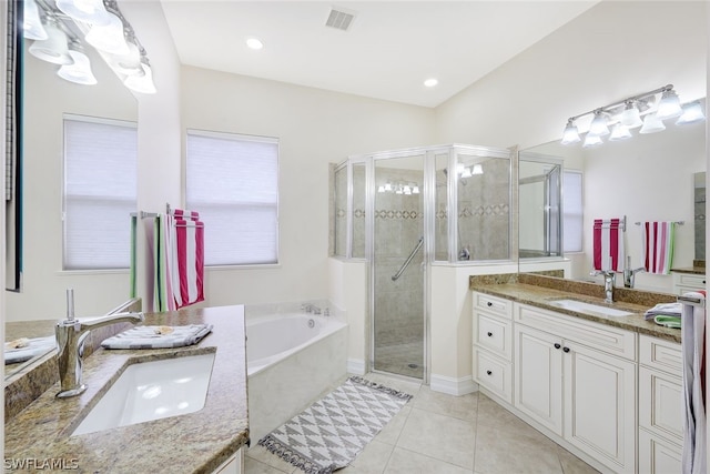 bathroom featuring vanity, independent shower and bath, and tile patterned flooring