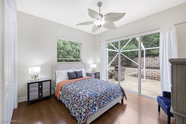 bedroom featuring dark hardwood / wood-style flooring, access to outside, and ceiling fan