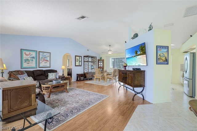 living room featuring light hardwood / wood-style flooring, ceiling fan, and vaulted ceiling