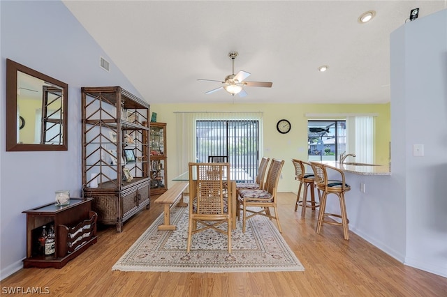 dining space featuring ceiling fan, light hardwood / wood-style floors, and lofted ceiling