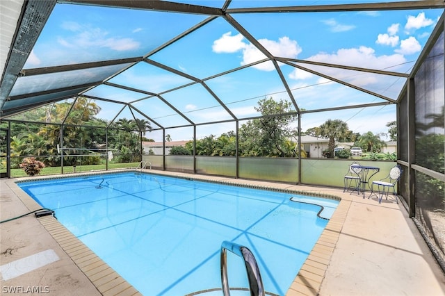 view of swimming pool featuring a lanai