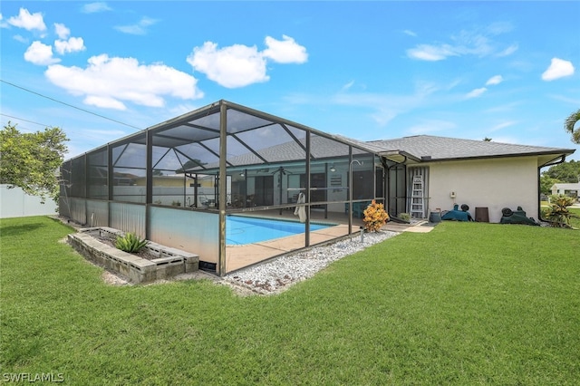 back of house with glass enclosure and a lawn