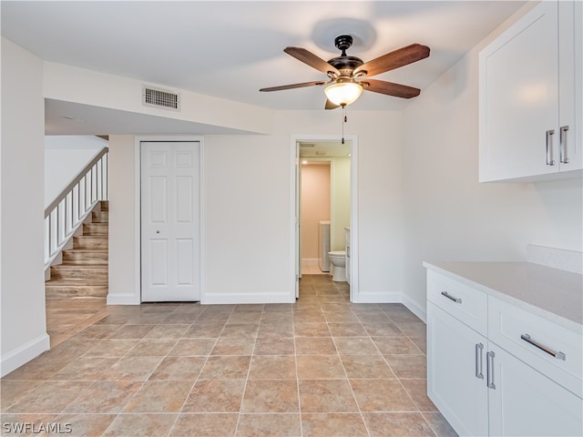 interior space with ceiling fan and light tile patterned floors