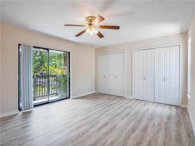 unfurnished bedroom featuring light hardwood / wood-style floors, multiple windows, and ceiling fan