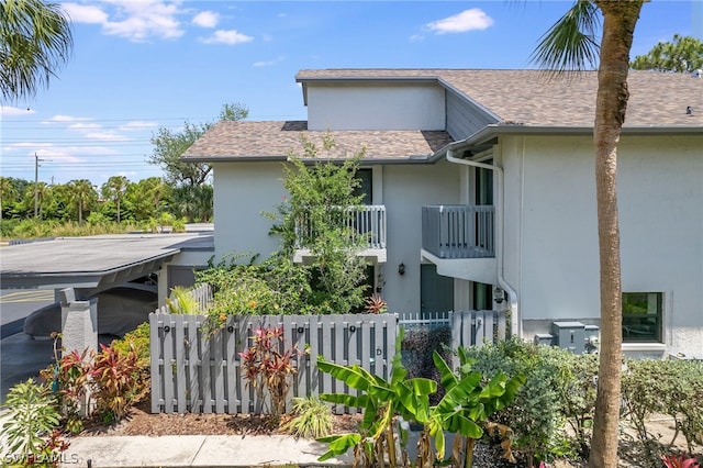 view of side of property with a balcony