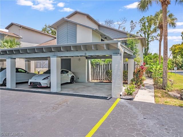 view of parking / parking lot featuring a carport