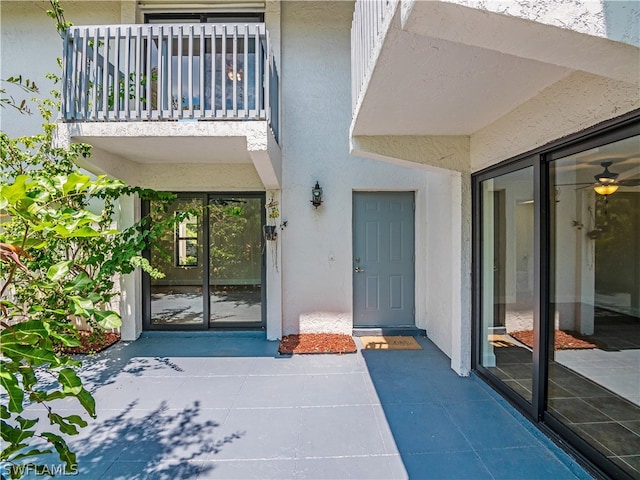 property entrance with a balcony and a patio area