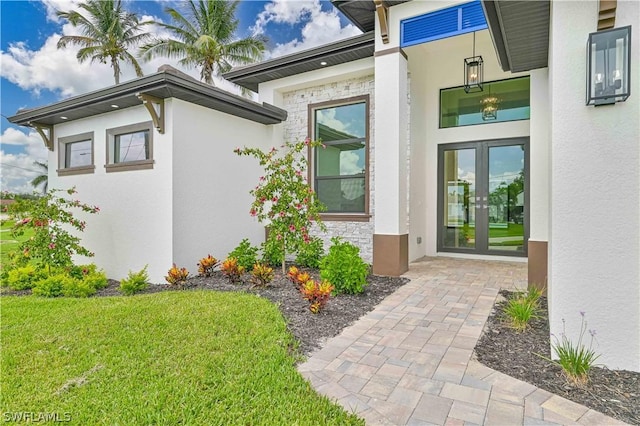 4406 SW 16th Pl, Cape Coral, FL 33914 - doorway to property with french doors, stucco siding, and a yard