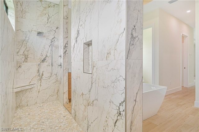 bathroom featuring hardwood / wood-style floors and separate shower and tub