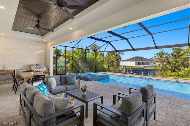 view of pool featuring outdoor lounge area, a patio, an in ground hot tub, and a lanai