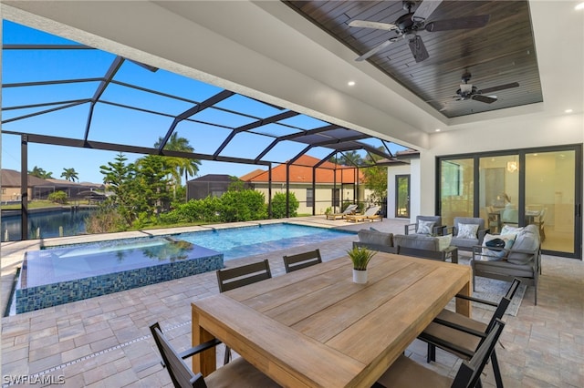 view of pool featuring a lanai, a patio area, and ceiling fan