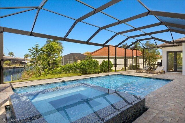 view of pool with glass enclosure, an in ground hot tub, and a patio area