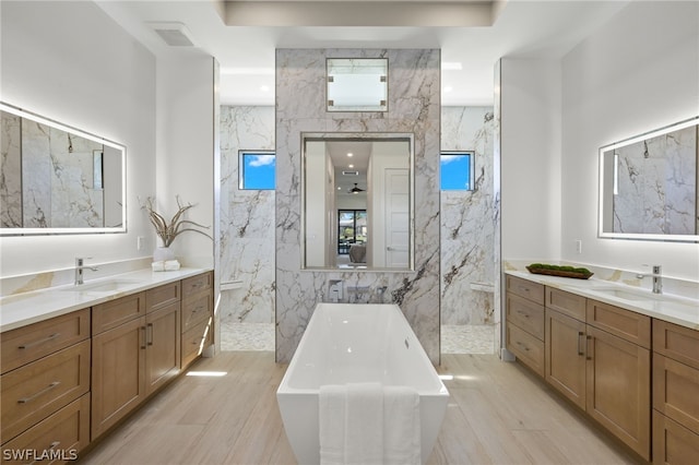 bathroom with vanity, plus walk in shower, and tile walls