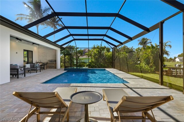 view of swimming pool with a lanai, ceiling fan, a patio, and an outdoor hangout area