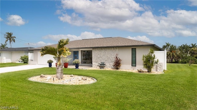 view of front of home with a front yard and a garage