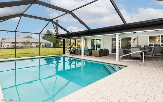 view of pool featuring an outdoor living space, a yard, a patio, and glass enclosure