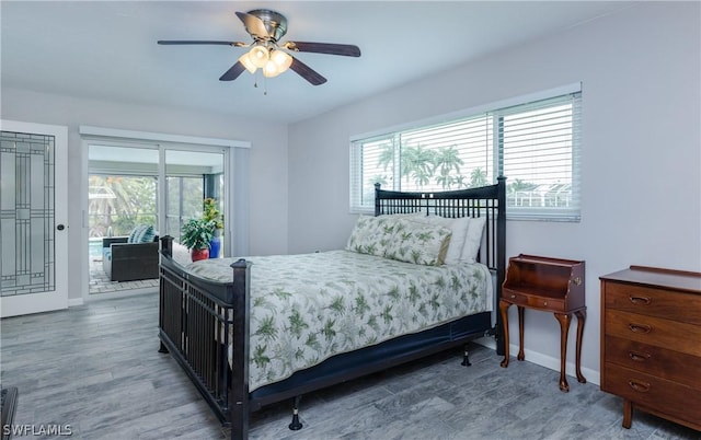 bedroom featuring ceiling fan, wood-type flooring, and access to outside