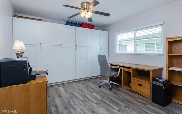 office area with light hardwood / wood-style floors and ceiling fan