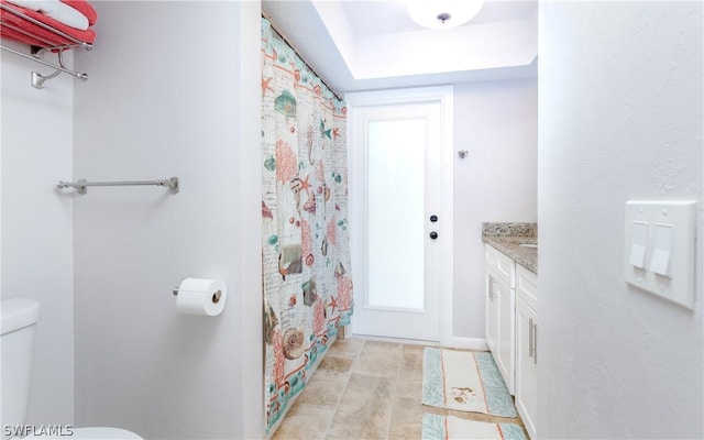 bathroom featuring toilet and vanity