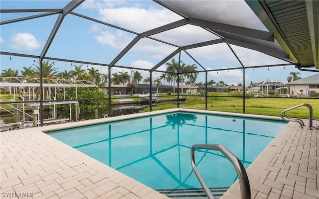 view of swimming pool featuring a lawn, a lanai, a water view, and a patio