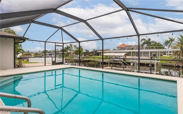 view of swimming pool featuring a lanai and a water view