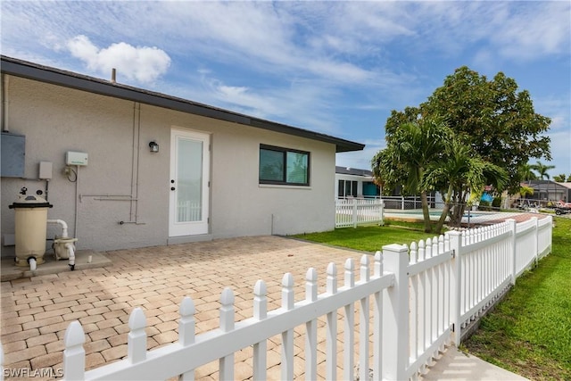 back of house featuring a patio area and electric panel