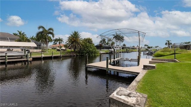 dock area with a yard and a water view