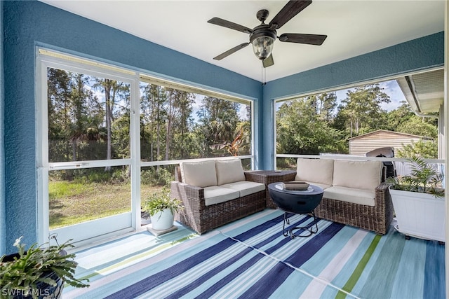 sunroom / solarium featuring ceiling fan