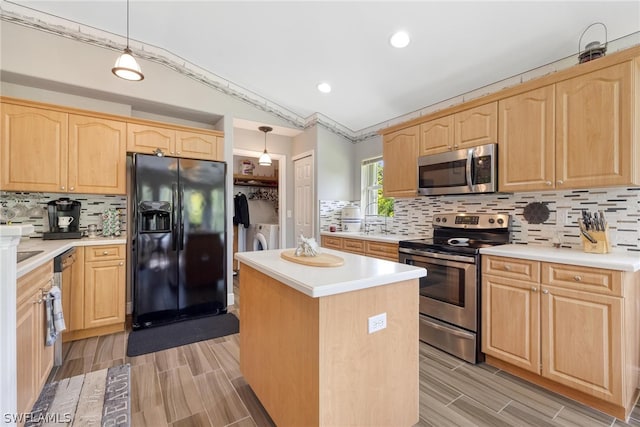 kitchen featuring a center island, appliances with stainless steel finishes, pendant lighting, and tasteful backsplash