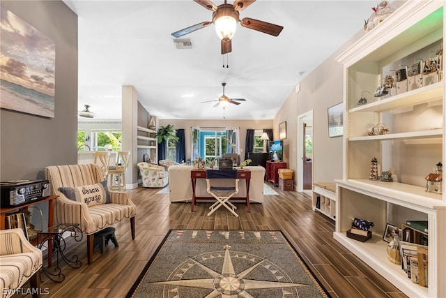 living room featuring ceiling fan, dark hardwood / wood-style flooring, and plenty of natural light