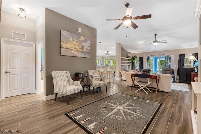 living room featuring hardwood / wood-style flooring and ceiling fan