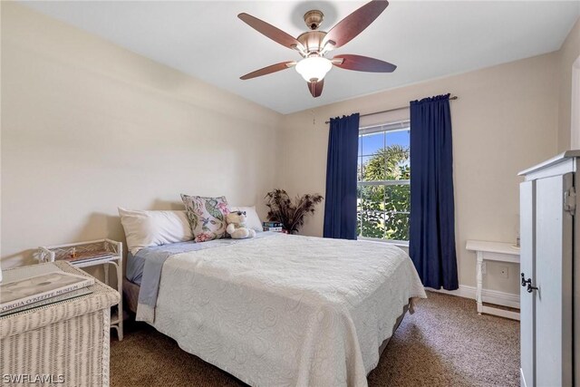 bedroom featuring dark colored carpet and ceiling fan